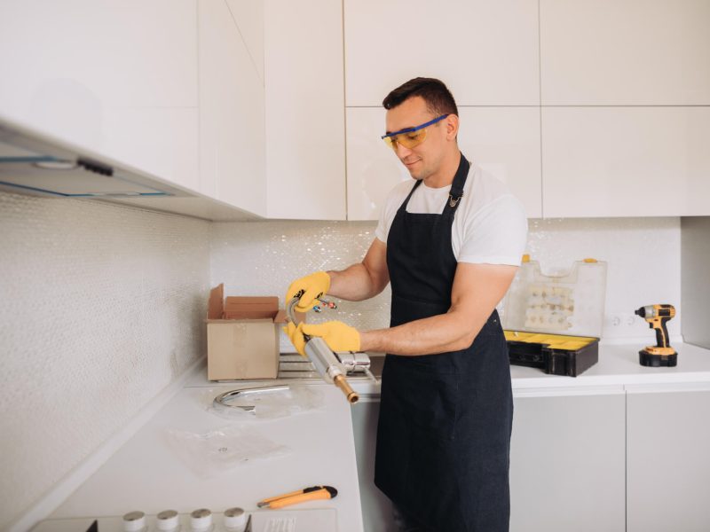 maintenance-man-is-going-to-install-plumbing-equipment-in-the-kitchen.jpg